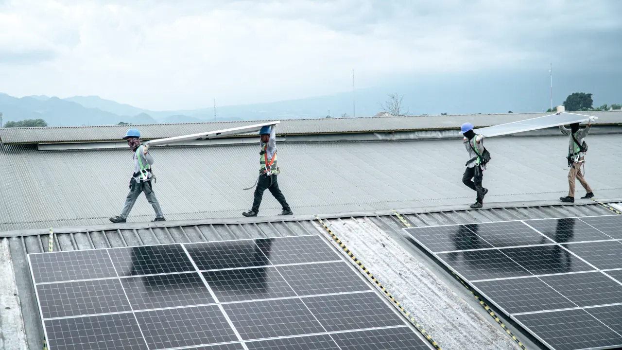 Rows of solar panels on the PT. Cave Sumber Berkat factory roof